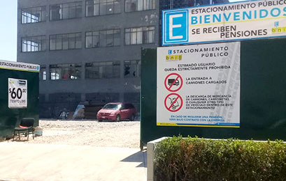 24-hour parking lot in Mexico with large security gate and staff