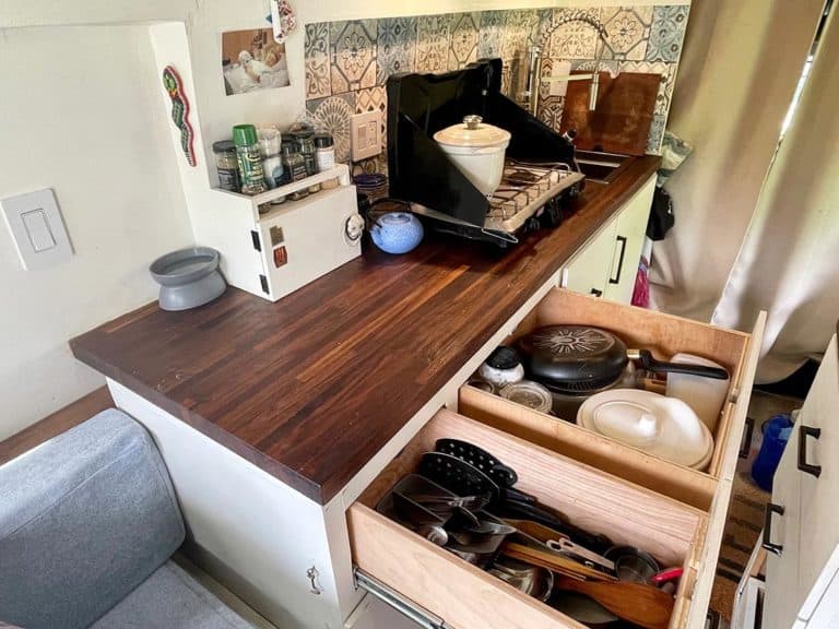 Kitchen counter with open drawers in a camper van