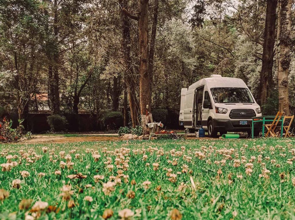 Ford transit camper van parked on the grass in a campground in Mexico