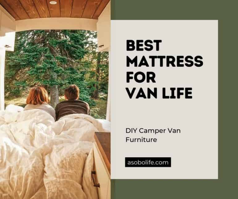 Couple laying on their bed mattress inside a camper van