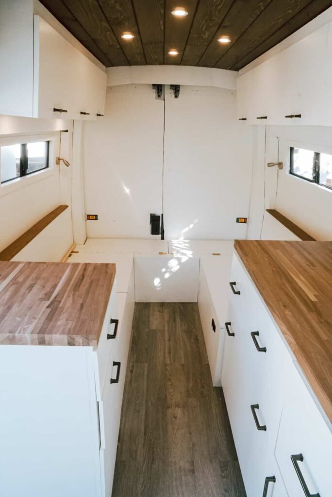 Two overhead cabinets and two kitchen counters installed in a camper van