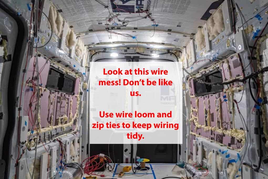 Van conversion interior that is in the middle of laying electrical wire
