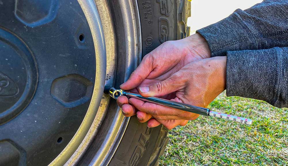 Checking tire pressure with an air pressure gauge