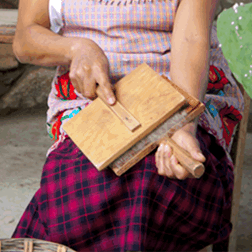 Brushing (carding) sheep's wool to make Mexican rugs from Oaxaca