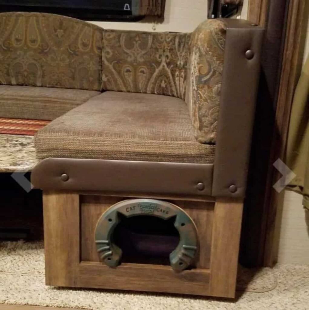 Kitty litter box located under RV sofa bench.