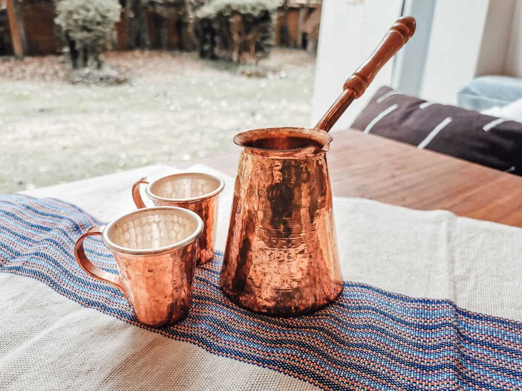 Two copper espresso cups and an Turkish copper coffee pot