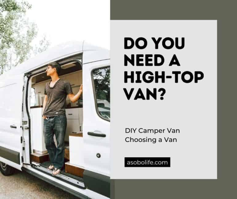 A man standing inside his high roof Ford Transit camper van.
