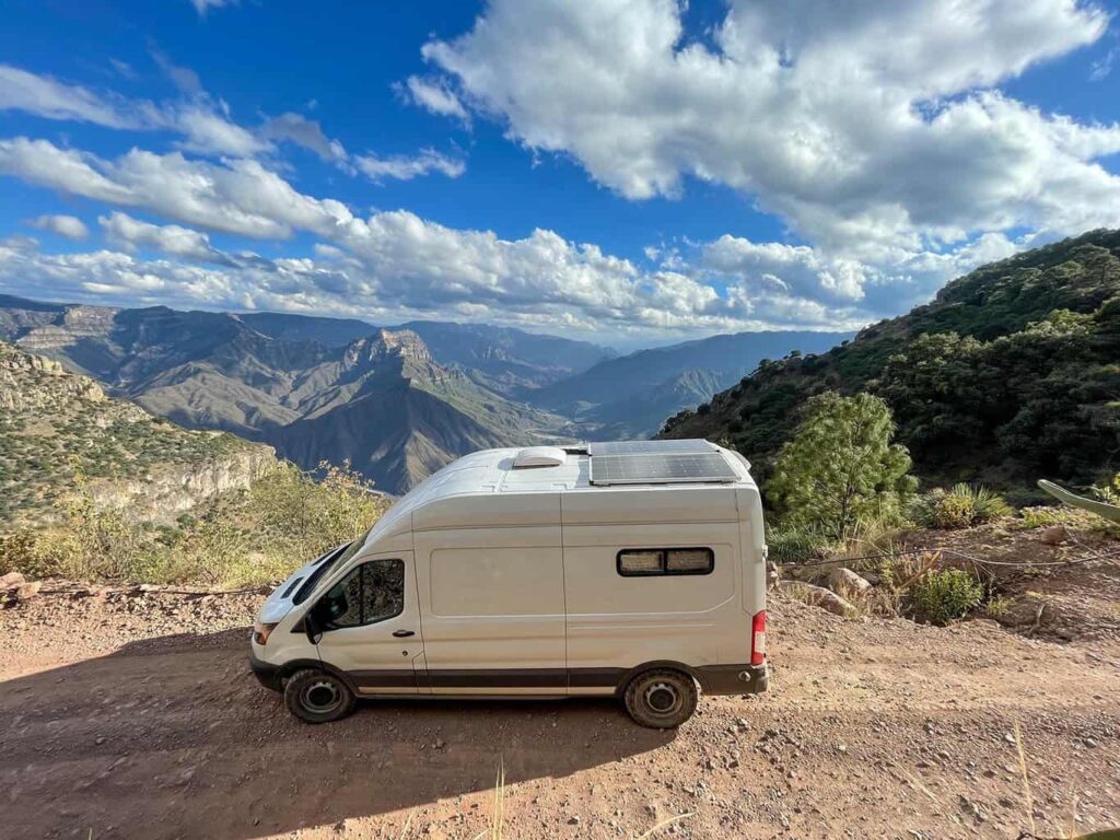 Ford Transit camper van driving on a dirt road to the bottom of Copper Canyon