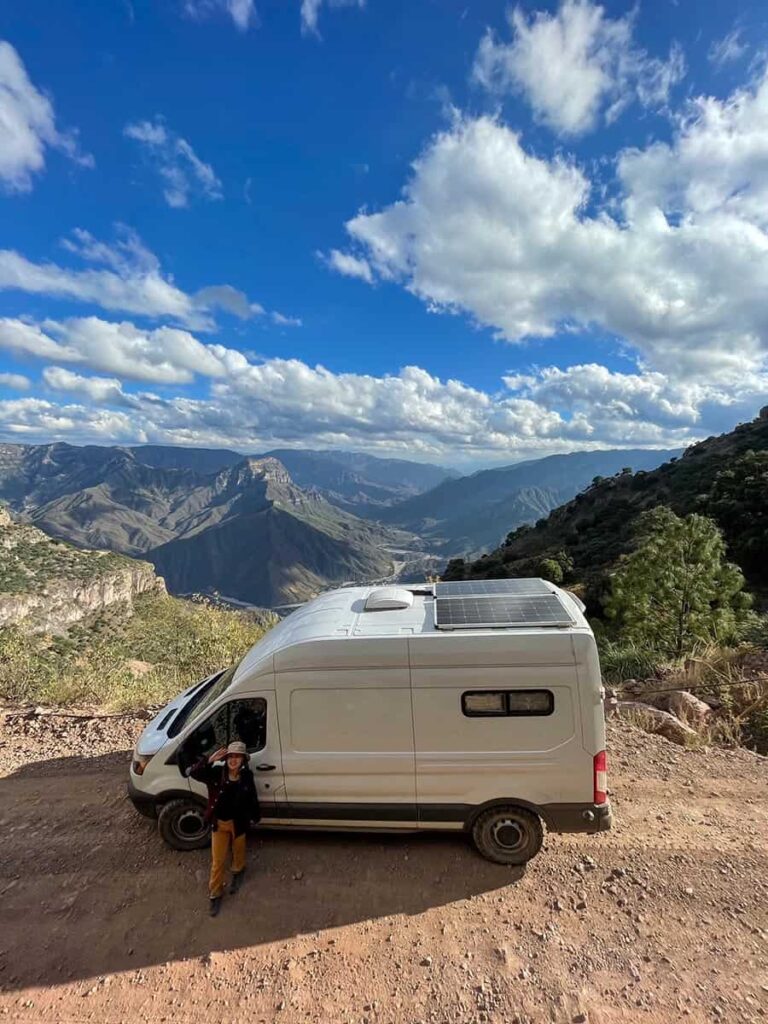 Ford Transit camper van parked on a dirt road while driving to the bottom of Copper Canyon in Mexico