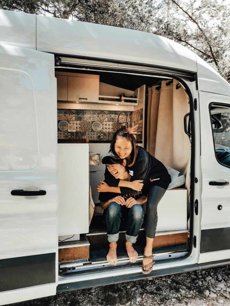 Woman hugging a man in a camper van