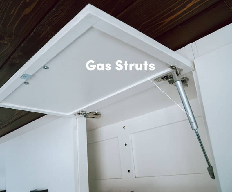 Gas struts installed on overhead cabinet fronts