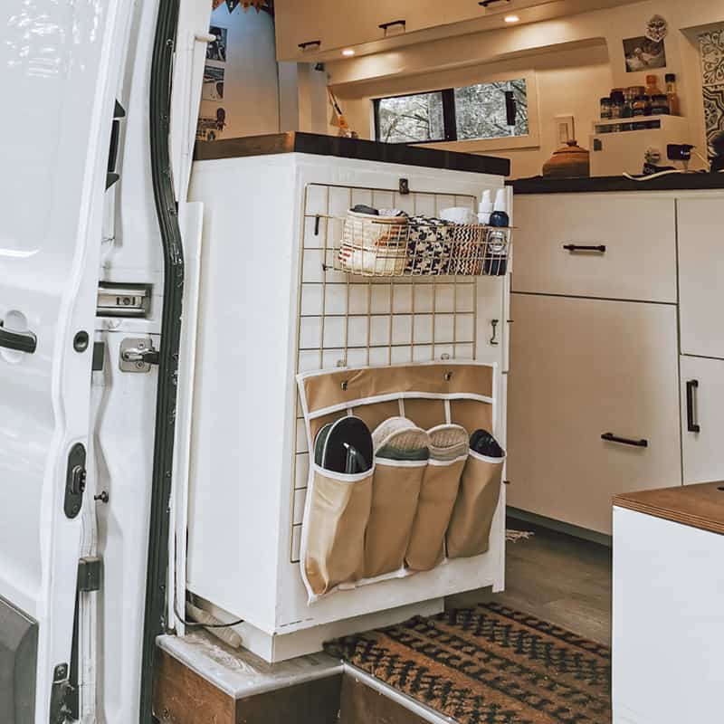 Wire grid board hung at the entrance of a camper van