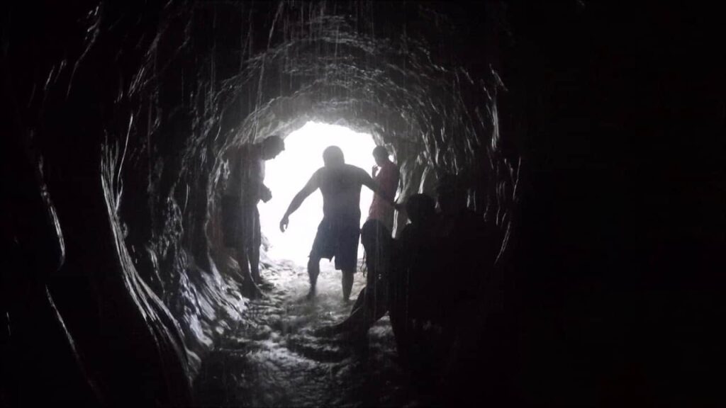 Man standing at the entrance of the cave at Grutas de Tolantongo