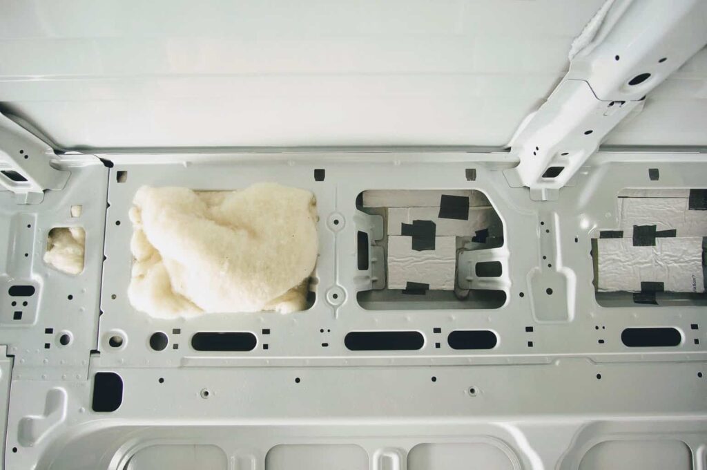 Sheep's wool stuffed inside camper van crevices