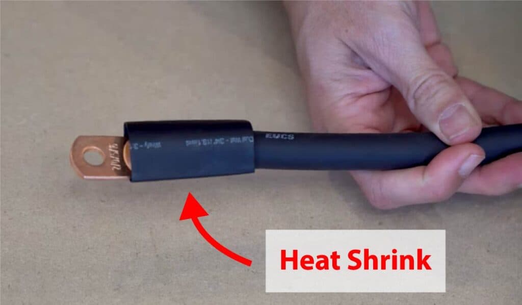 A black heat shrink sleeve placed over electrical wire.