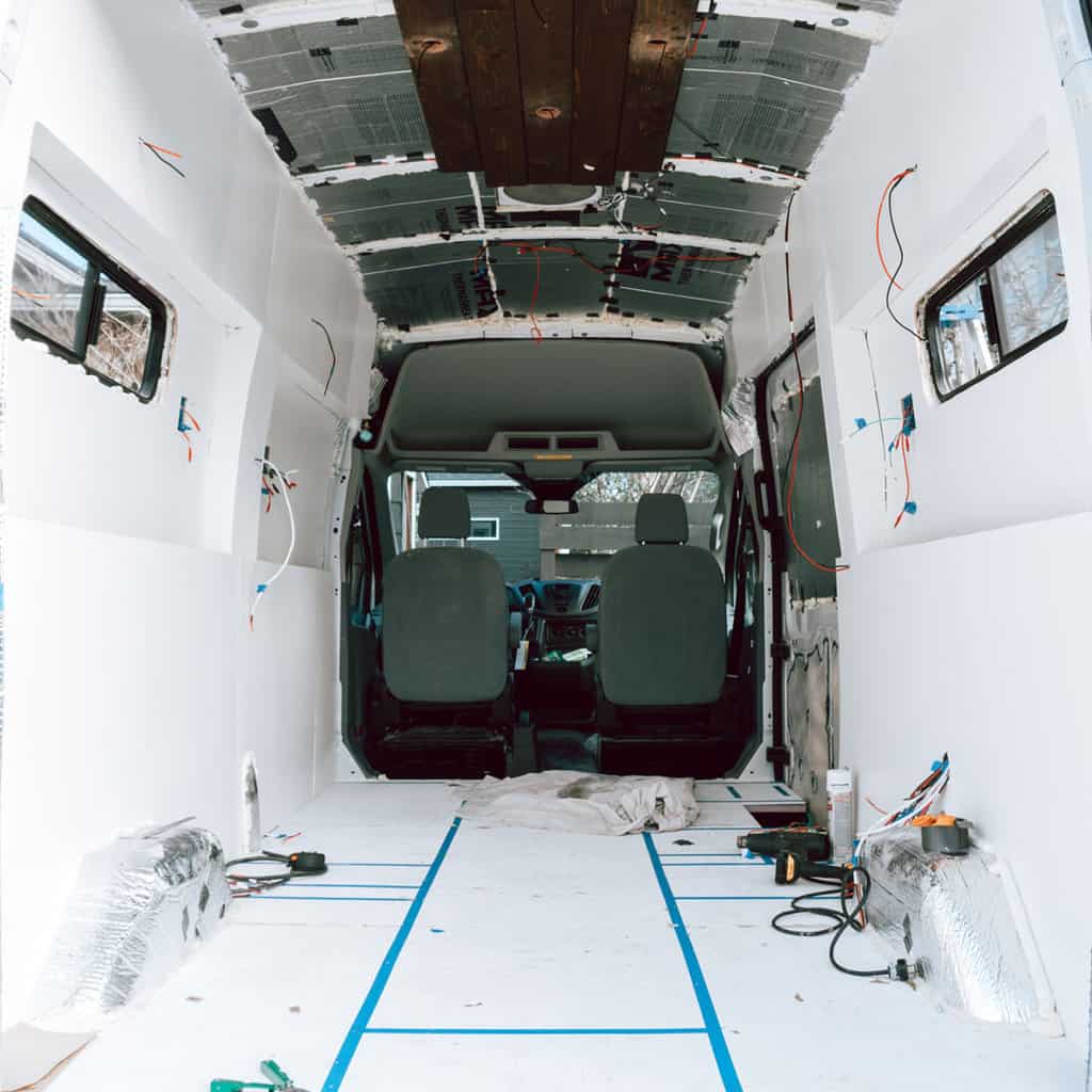 Camper van interior showing white plywood walls