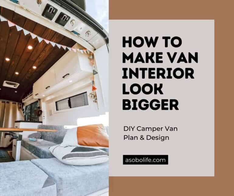 A roomy camper van interior with couch, table, and kitchen counter.