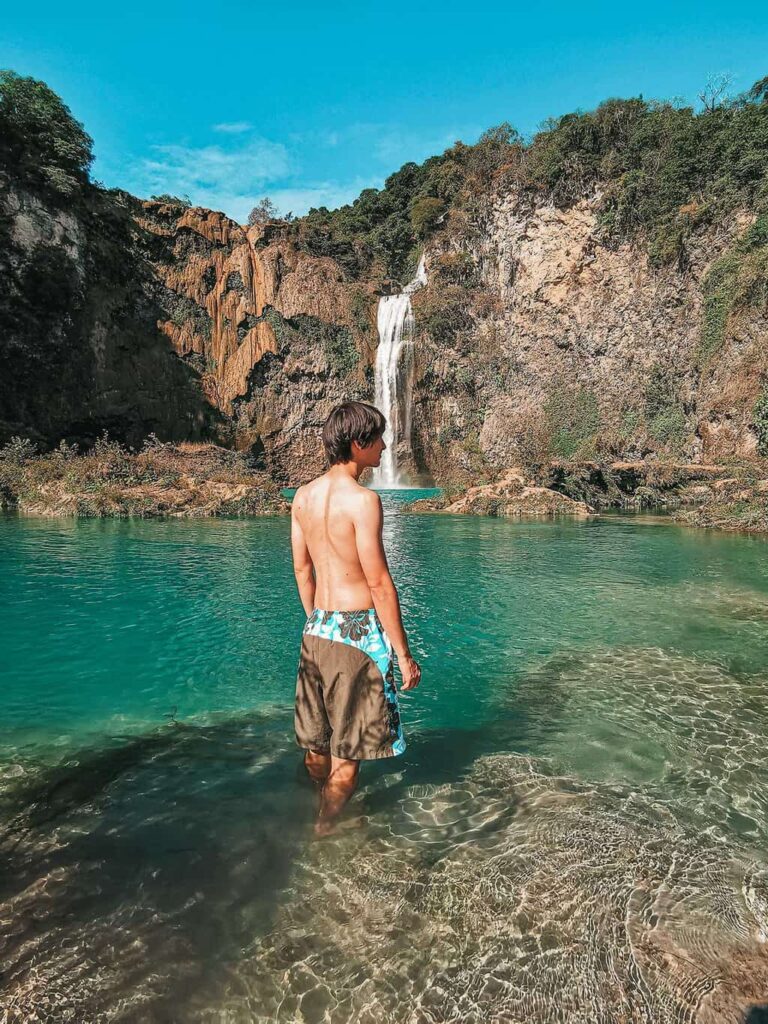 Eric standing in front of a waterfall in Mexico's Huasteca Potosina region