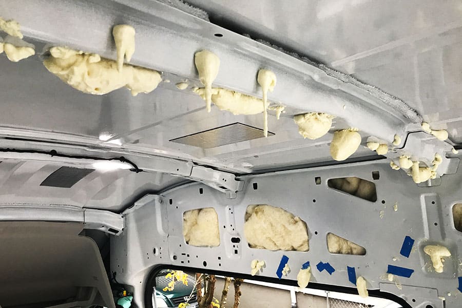 Closed-cell spray foam added inside the cross ribs of a van's ceiling