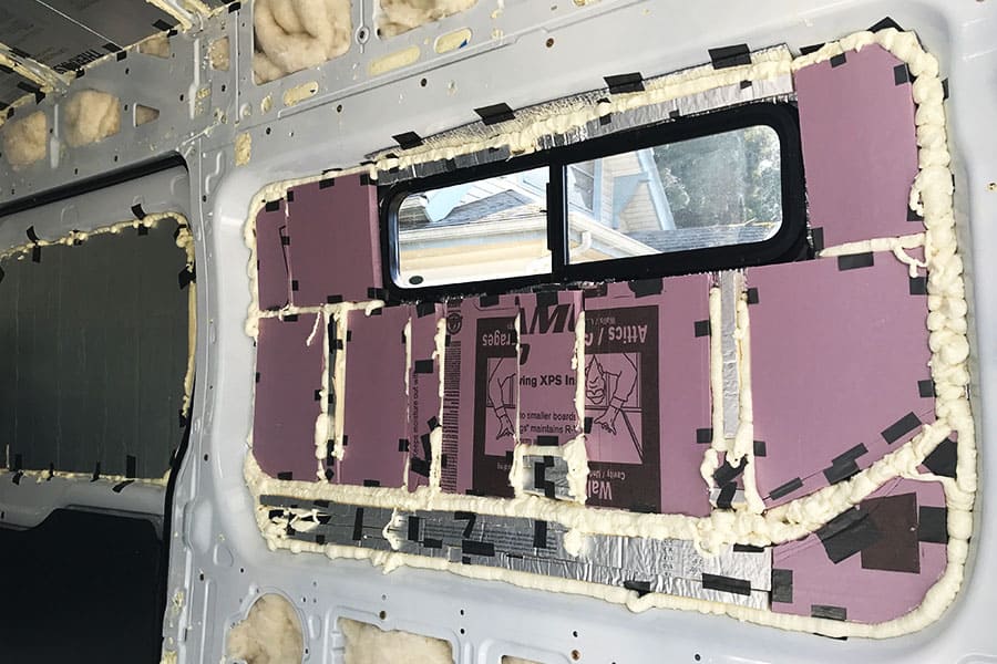 Adding foam board insulation to the side of a camper van