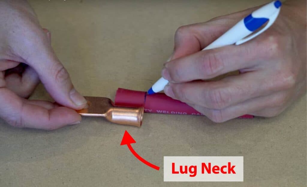 Placing the copper lug next to electric wire and measuring the length of the lug neck onto the wire's jacket.