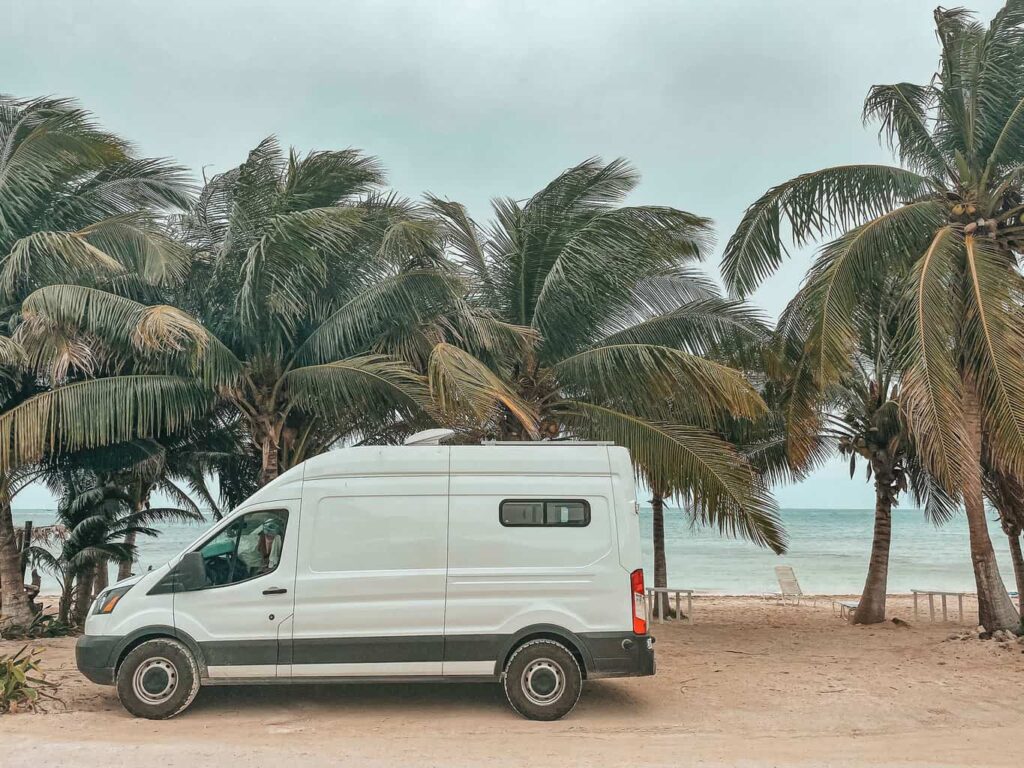 Ford Transit camper van parked by the beach in Mahahual, Mexico