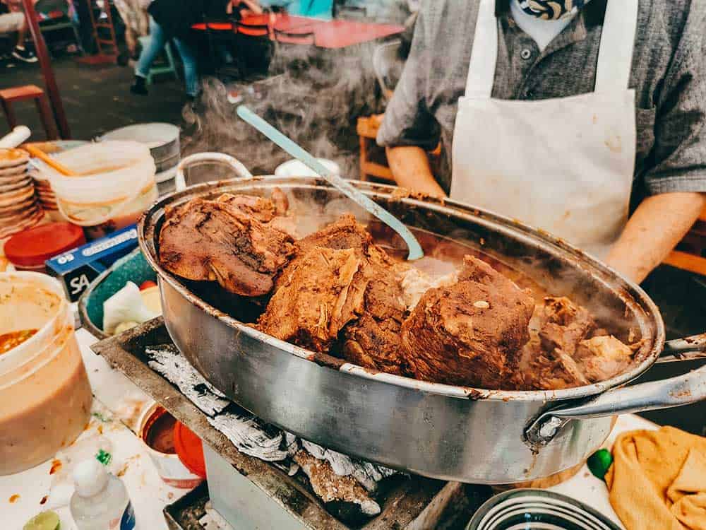 Carnitas pork meat roasting in a pot in Quiroga town, Michoacan