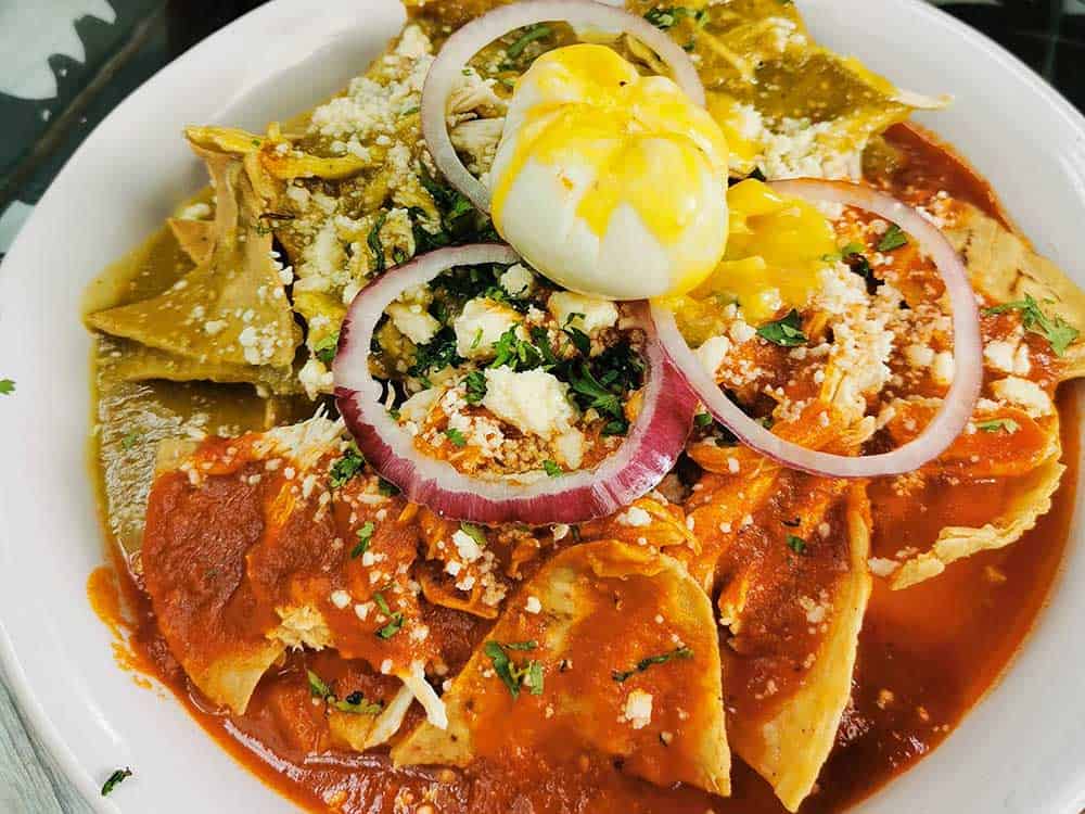 Tortilla chips with red and green salsa on top