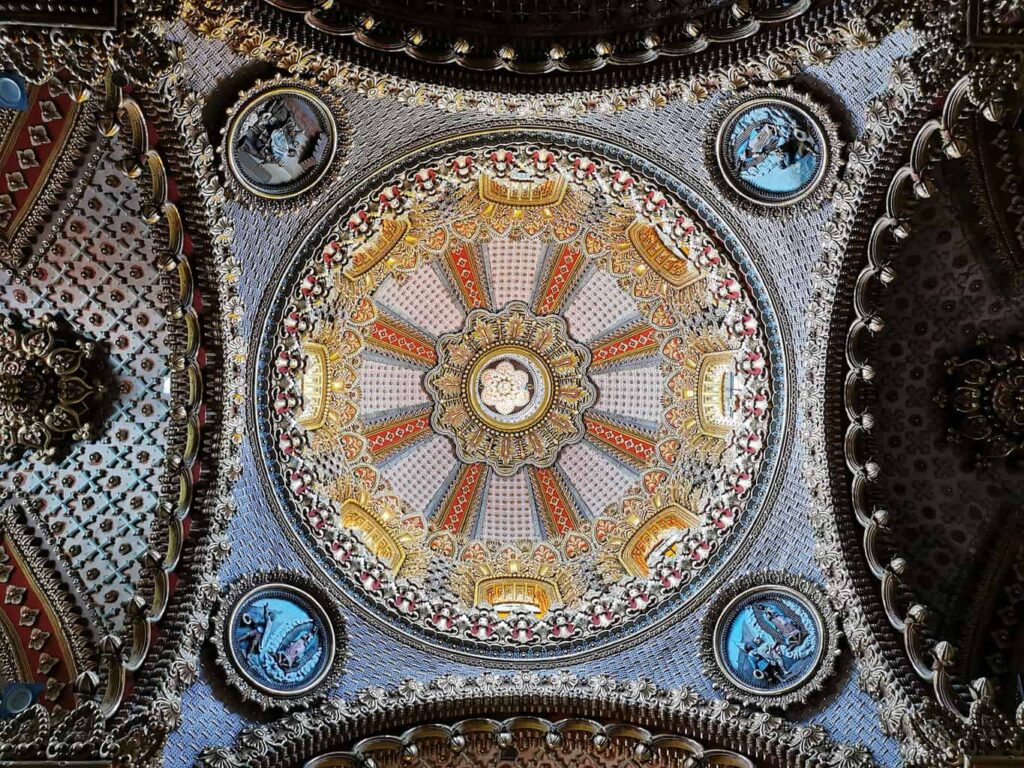 Ornate red, white, and yellow decoration on the ceiling of Morelia's main cathedral