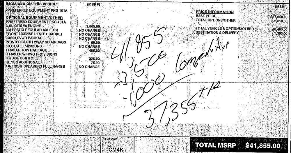 A dealership's hand written discount offer on a scanned window sticker