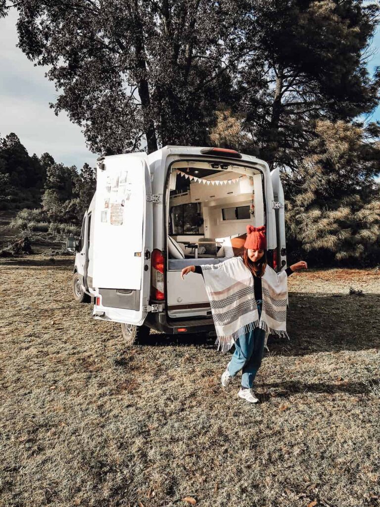 Yuko showing off her Mexican poncho in front of her camper van