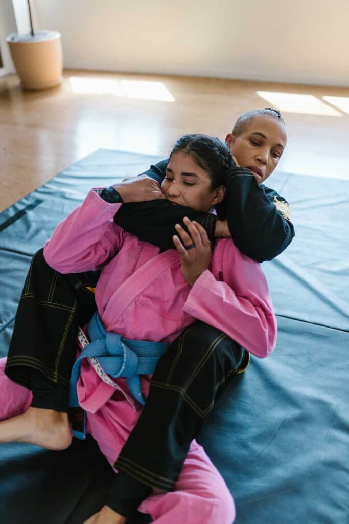Two women wrestling on a mat