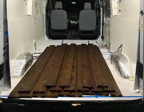 Drying the stained cedar plank boards inside our camper van