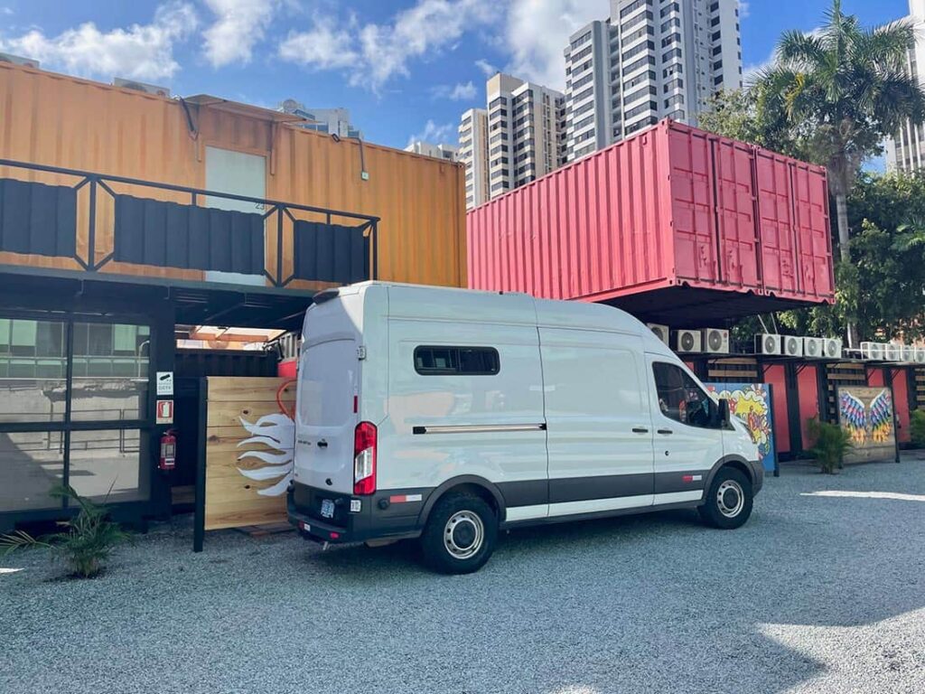 Camper van parked outside Nomada Container Hotel in Panama City