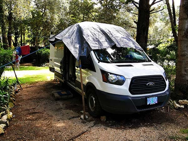 Placing tarp over campervan during rainy season