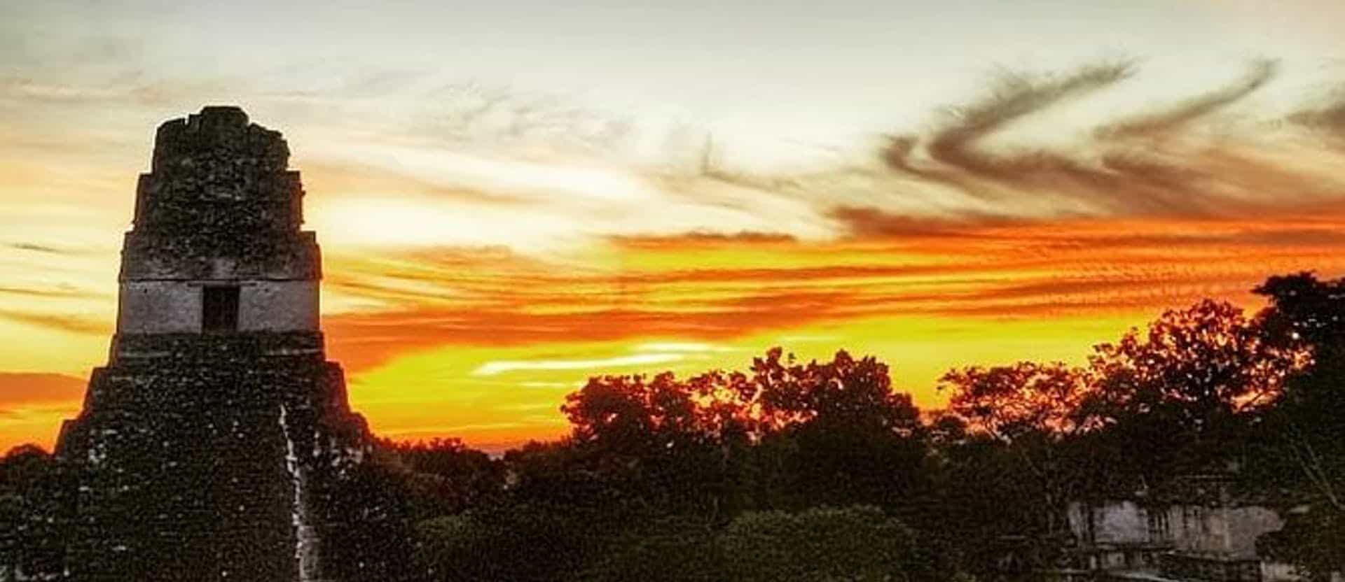 Sun rising behind the Tikal ruins