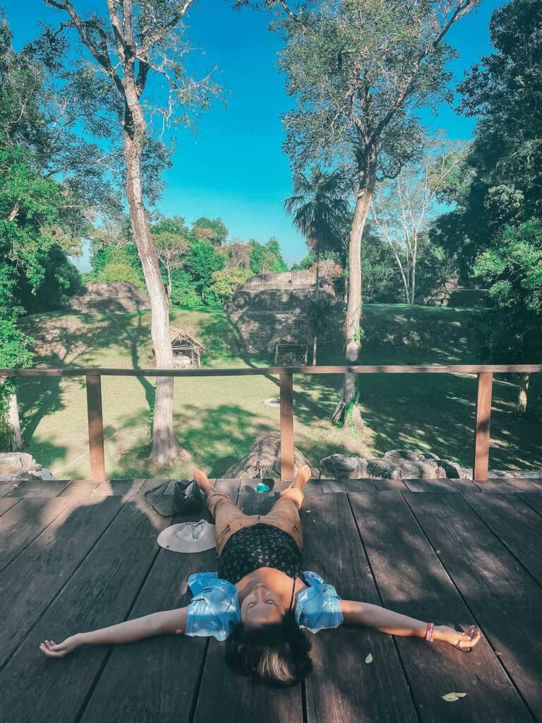 Yuko sleeping at the viewpoint of the group E ruins in Uaxactun, Guatemala
