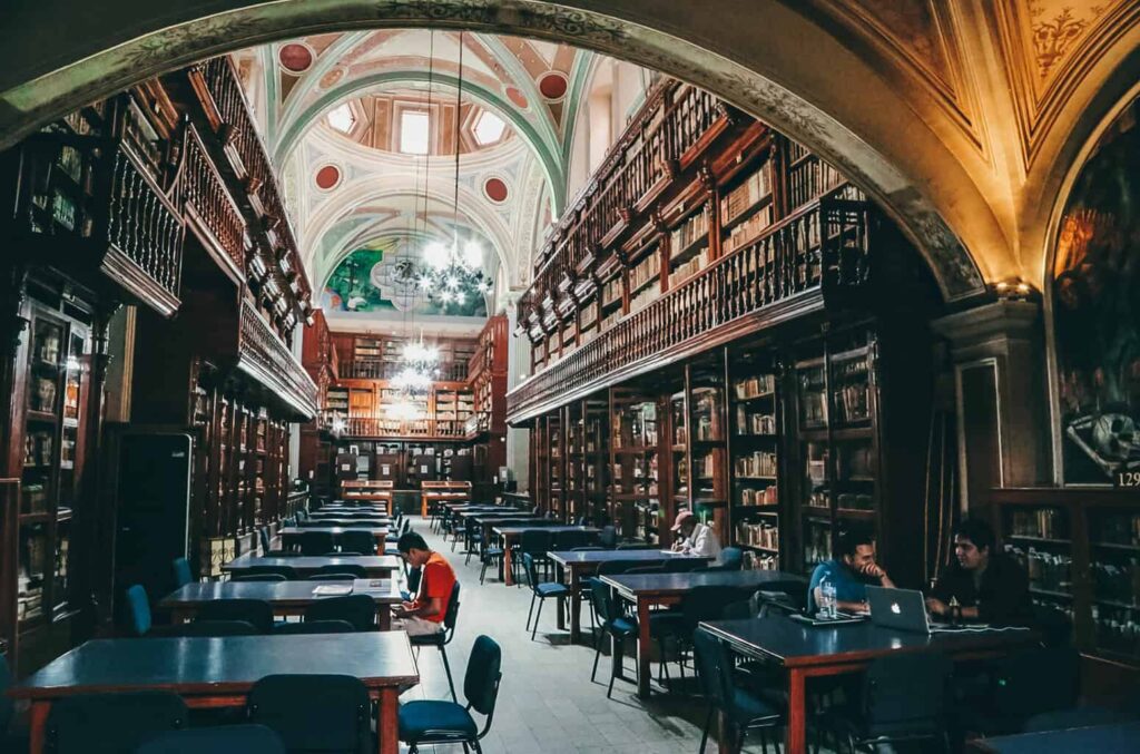 Inside the university library in Morelia with books shelves and students studying
