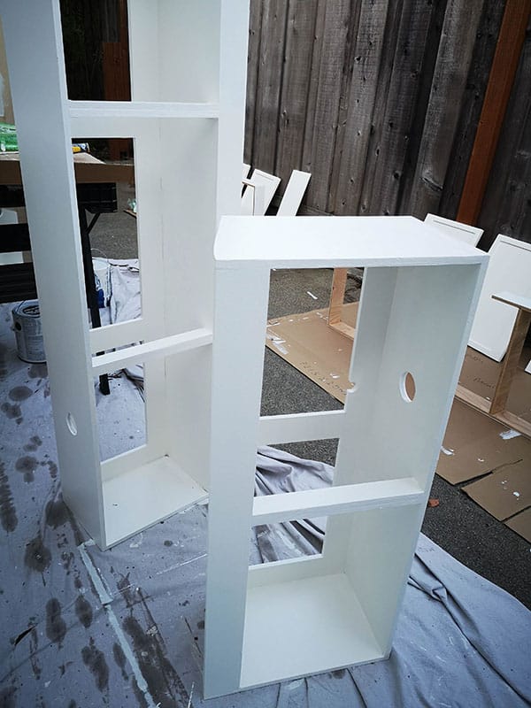 Two overhead cabinets drying after being painted