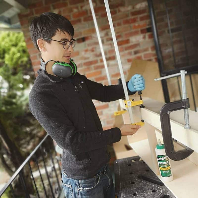 Eric adjusting the long clamps while building overhead cabinets