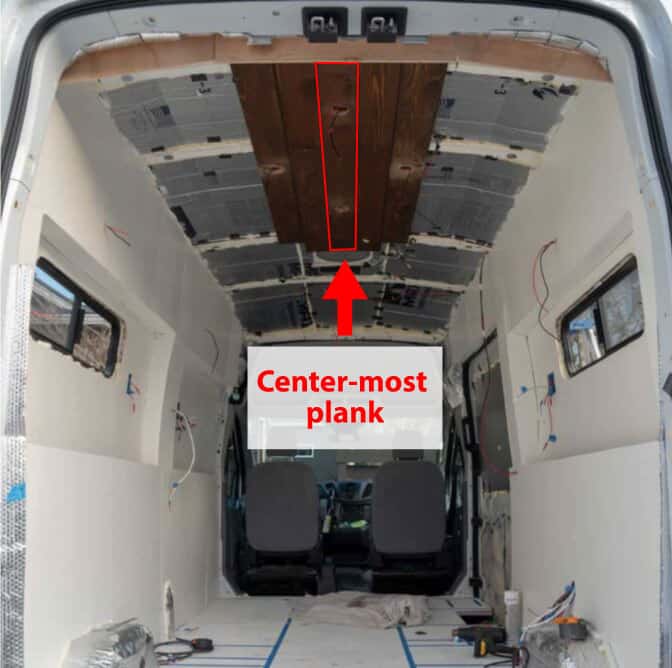 In the early stages of installing cedar plank boards on our camper van ceiling.