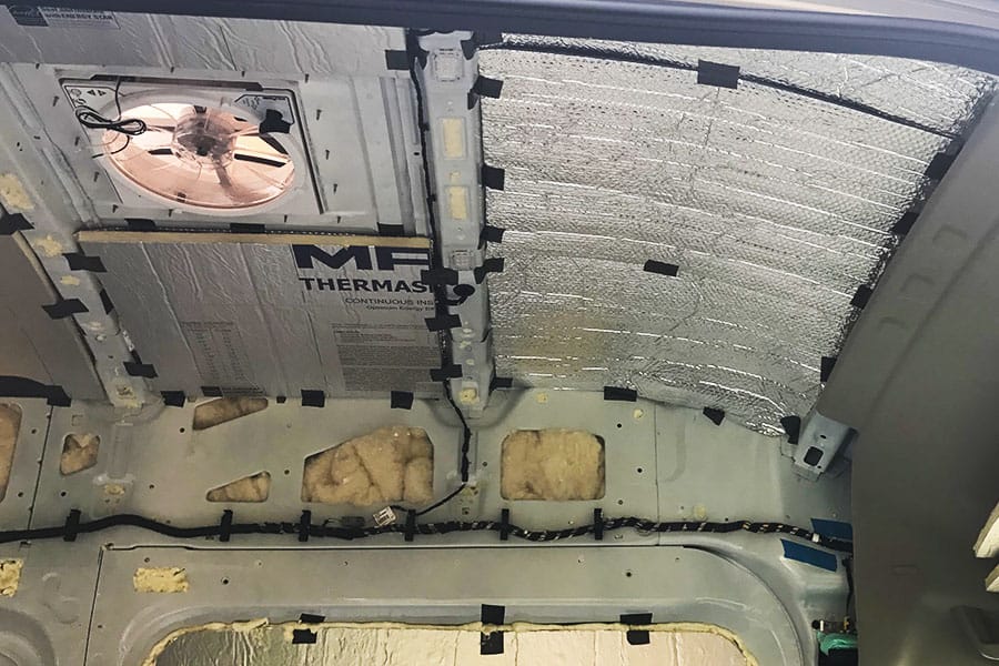 Polyiso foam board insulation added to the ceiling of a camper van