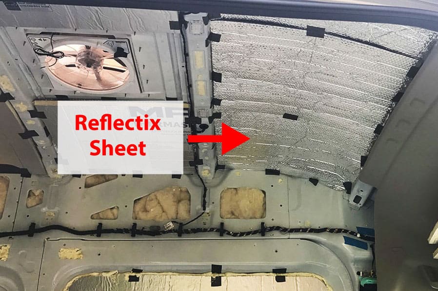 Installing a layer of Reflectix insulation to the roof of a camper van