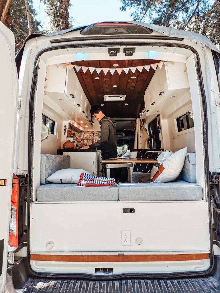 Man cooking inside a camper van