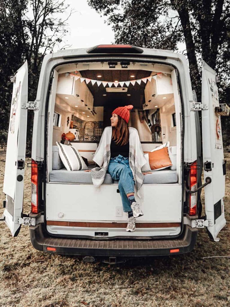 Yuko sitting by the back of our van looking out