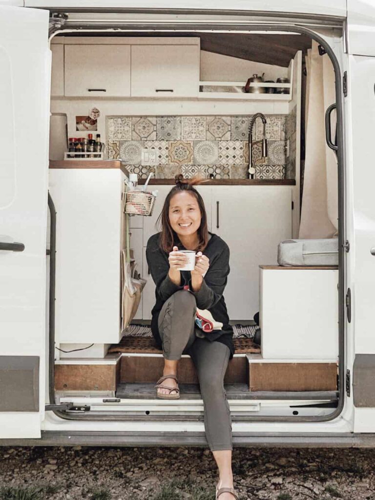 Yuko sitting by the sliding door of our camper van
