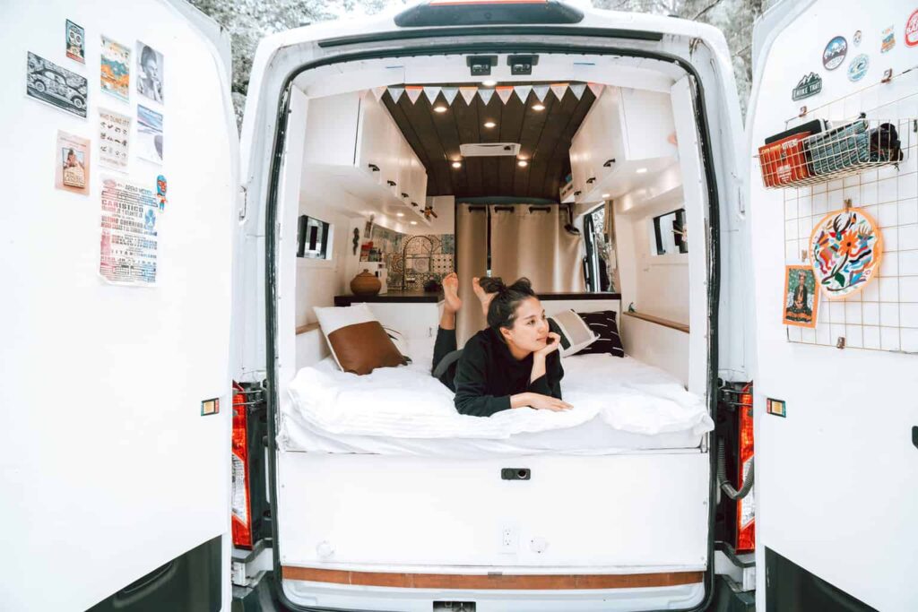 Woman laying inside a camper van