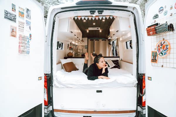 Woman laying down inside a camper van