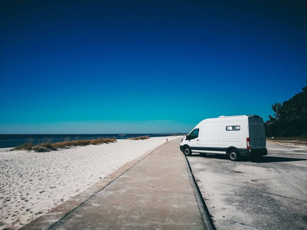 Camper van parked at a parking lot by the beach