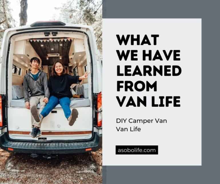 A couple sitting out the back of their camper van
